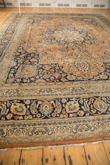 Vintage Meshed carpet's navy blue, ivory, and bronze intricate border patterns with pale rust fringe.