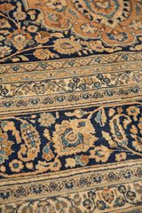 Intricate scrolling vinery, palmettes, and leaves in navy blue, pale rust, and ivory.