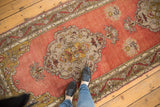 Vintage Anatolian runner: dusty rose field, intricate scalloped roundel medallion.