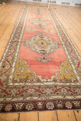 Vintage Anatolian runner's intricate meandering vine border with serrated contour.