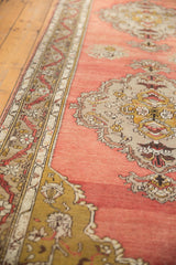 Anatolian runner with intricate meandering vine border and scalloped medallion, dusty rose field.