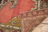 Folded corner of vintage Anatolian runner revealing dusty rose pile and hand-knotted foundation.
