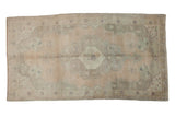 Distressed vintage Oushak carpet, oversized medallion and spandrels, olive, ivory, beige, apricot.