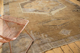 Distressed Oushak rug's geometric medallion with serrated contour in coffee brown and antique ivory.
