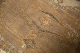 Distressed Oushak carpet texture with worn knot heads, visible foundation, and brown shades.