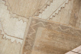 Close-up of vintage distressed Oushak rug's back, side selvage, and low-pile texture.