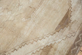 Vintage distressed Oushak carpet texture with tone-on-tone beige abrash and worn low pile.