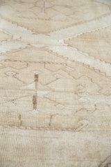 Even low pile texture with tonal geometric patterns on a distressed Oushak carpet.