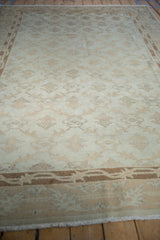 Distressed texture and faded floral lattice pattern in antique ivory and pale coffee bronze.