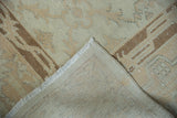 Distressed vintage Sparta rug fold revealing worn beige pile and tightly hand-knotted back.