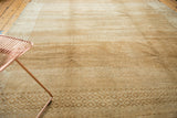 Distressed vintage Oushak rug pile revealing beige and sand abrashes with geometric patterns.