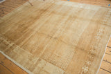 Distressed vintage Oushak carpet close-up, highlighting intricate lattice pattern, abrashes, and wear.
