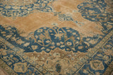 Distressed Sivas carpet detail with scalloped dusty teal border and apricot field.