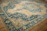 Distressed texture and floral motifs in dusty teal and apricot on a vintage Sivas rug.