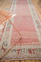 Distressed vintage Oushak runner detail: worn cherry red and ivory boteh motifs, intact selvage.