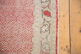Distressed vintage Oushak runner's cherry red lattice boteh motif and pale mauve border.