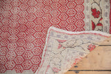 Distressed Oushak runner with cherry red and ivory pattern, visible hand-knotted foundation and selvage.