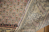 Vintage Oushak runner's distressed pile showing faint foundation and hand-knotted weave.