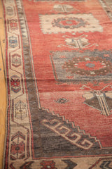 Distressed Oushak runner with striated madder red field, charcoal patterns, and antique ivory border.
