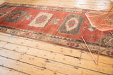 Distressed Oushak rug runner with madder root red field and geometric side border.