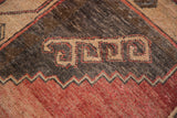 Distressed Oushak detail of symmetric motif, striated madder red, charcoal and antique ivory.