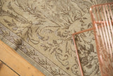 Distressed beige vintage Sparta rug showing ornamental brown Rococo motifs and border.