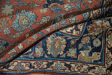 Folded vintage Tabriz: brick red field, navy blue border with Safavid palmette, lotus motifs.
