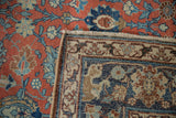 Vintage Tabriz rug folded corner, showcasing brick red palmette pile, woven foundation, and fringe.