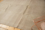 Distressed vintage Oushak carpet displaying neutral sand, beige, and ivory tones.