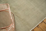 Detail of a distressed vintage Oushak rug, showing pale dusty sea foam green texture.