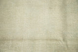 Close-up of distressed vintage Oushak carpet in pale dusty sea foam green, showing textural weave.