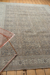 Muted silver-brown and antique ivory floral patterns on a vintage distressed Sparta rug.