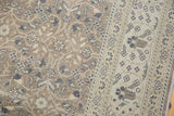 Vintage Distressed Sparta rug with intricate floral field and decorative ivory border.