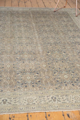 Distressed Sparta carpet with allover intricate floral pattern in muted beige and ivory.