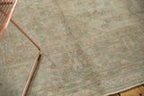 Muted floral tendrils and distressed texture on a vintage Sivas carpet.