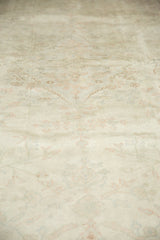 Distressed Sivas carpet pile, revealing faint floral patterns in antique ivory, pale red, and green.