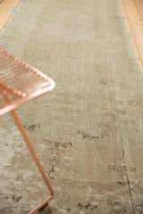 Distressed vintage Oushak runner showcasing tone-on-tone texture and faint patterns.