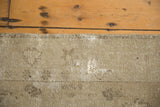 Distressed vintage Oushak rug edge showing low pile, foundation, and abrashed sand tones.