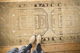 Vintage distressed Oushak runner showcasing primitive guls and even wear.