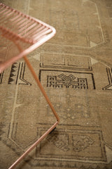 Distressed vintage Oushak rug detail: primitive geometric guls in brown and beige.