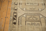 Distressed Oushak rug showing geometric guls in antique ivory and coffee brown.