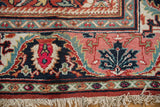 Cherry red field with bold navy blue palmette, complex border patterns, and original fringe.