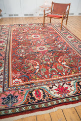 Vintage Mahalati carpet corner showing plain weave fringe and intricate red, ivory, navy border.