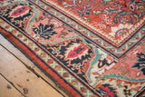 Close-up of a vintage Persian Mahalati rug border with blush meandering vine and cherry red palmettes.