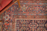 Persian Mahal carpet's madder root red field herati motif, navy, sky blue, and green border.