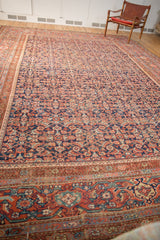 Antique Mahal carpet's madder root red border with blue accents and the repeating Herati field.