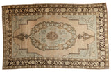 Vintage Distressed Oushak Carpet with scalloped medallion, blush field, faded seafoam, and dark brown borders, 6'6