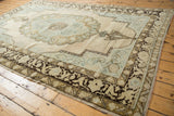 Distressed pile and abstract dark brown border motifs on vintage Oushak rug.