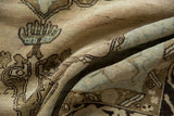 Textural detail of distressed vintage Oushak rug with worn pale beige pile, sage green, and brown motifs.
