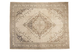 Decorative distressed Oushak carpet, oversized medallion with scalloped contours, ivory field, muted brown motifs.